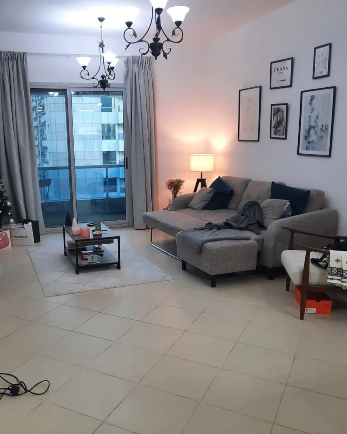 Living room before, with old tile and cluttered furniture