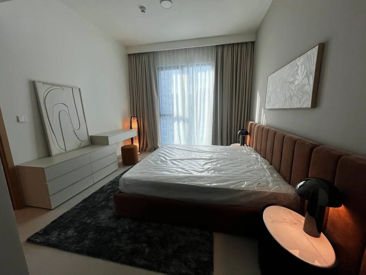 Bedroom with dresser and relief art